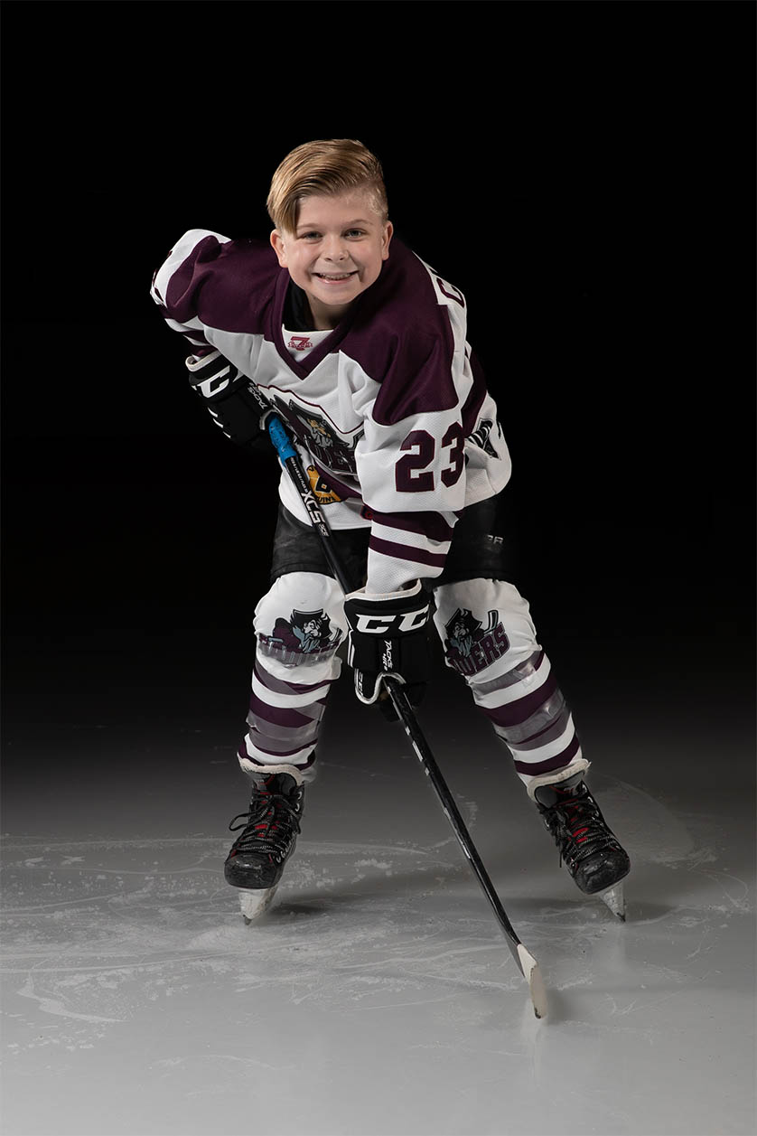 Spotlighed individual hockey photo on dark rink
